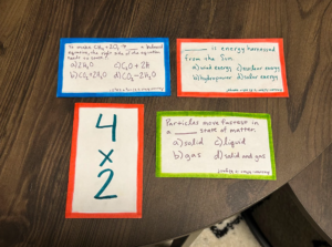 Front side of 3 example Jeopardy cards and 1 example UNO card